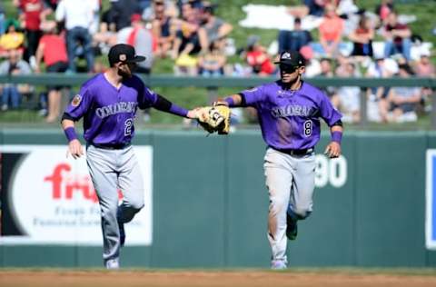 SCOTTSDALE, AZ – FEBRUARY 25: Gerardo Parra #8 of the Colorado Rockies is by teammate Trevor Story #27 after making a diving catch against the Arizona Diamondbacks during the spring training game at Salt River Fields at Talking Stick on February 25, 2017 in Scottsdale, Arizona. (Photo by Jennifer Stewart/Getty Images)