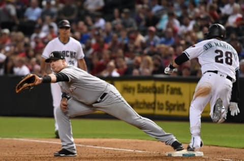 PHOENIX, AZ – SEPTEMBER 22: JD Martinez #28 of the Arizona Diamondbacks beats out a throw to first base as Justin Bour #41 of the Miami Marlins catches the throw from third base during the sixth inning at Chase Field on September 22, 2017 in Phoenix, Arizona. (Photo by Norm Hall/Getty Images)