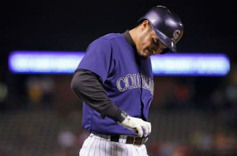 DENVER, CO – MAY 23: Nolan Arenado #28 of the Colorado Rockies grimaces after being hit in the hand with a pitch by starting pitcher Yusmeiro Petit #52 of the San Francisco Giants in the first inning during the second game of a double header at Coors Field on May 23, 2015 in Denver, Colorado. (Photo by Doug Pensinger/Getty Images)