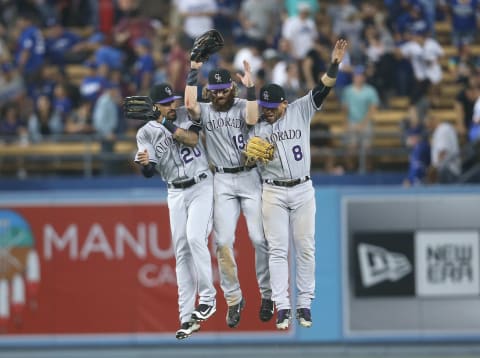 LOS ANGELES, CA – SEPTEMBER 09: Outfielders Ian Desmond #20, Charlie Blackmon #19, and Gerado Parra #8 of the Colorado Rockies jump together to celebrate after the final out against the Los Angeles Dodgers at Dodger Stadium on September 9, 2017 in Los Angeles, California. The Rockies won 6-5. (Photo by Stephen Dunn/Getty Images)