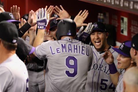 PHOENIX, AZ – MARCH 29: Carlos Estevez (R) #54 of the Colorado Rockies high fives DJ LeMahieu #9 after LeMahieu hit a solo home run against the Arizona Diamondbacks during the first inning of the openning day MLB game at Chase Field on March 29, 2018 in Phoenix, Arizona. (Photo by Christian Petersen/Getty Images)