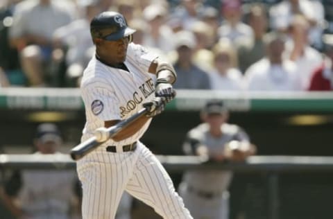 DENVER – JULY 18: Shortstop Juan Uribe #4 of the Colorado Rockies makes contact with the ball during the MLB game against the Arizona Diamondbacks on July 18, 2002 at Coors Field in Denver, Colorado. The Rockies won 6-4. (Photo by Brian Bahr/Getty Images)