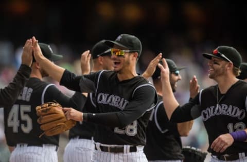 DENVER, CO – JULY 24: Nolan Arenado #28 of the Colorado Rockies laughs as he celebrates after a 7-2 win over the Atlanta Braves at Coors Field on July 24, 2016 in Denver, Colorado. (Photo by Dustin Bradford/Getty Images)