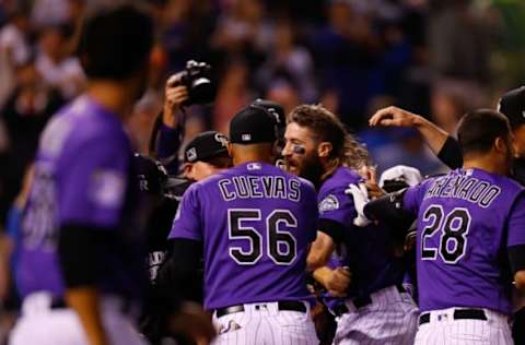 DENVER, CO – JULY 25: Charlie Blackmon #19 of the Colorado Rockies is mobbed by teammates after he hit a walk-off solo home run in the ninth inning against the Houston Astros during interleague play at Coors Field on July 25, 2018 in Denver, Colorado. The Rockies defeated the Astros 3-2. (Photo by Justin Edmonds/Getty Images)