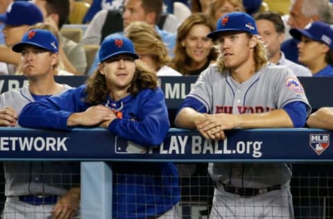 LOS ANGELES, CA – OCTOBER 15: Jacob deGrom #48 and Noah Syndergaard #34 of the New York Mets watch from the dugout in the eighth inning against the Los Angeles Dodgers in game five of the National League Division Series at Dodger Stadium on October 15, 2015 in Los Angeles, California. (Photo by Sean M. Haffey/Getty Images)