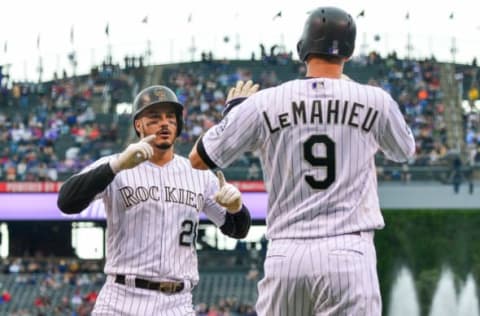 DENVER, CO – JUNE 24: Nolan Arenado #28 of the Colorado Rockies celebrates as he crosses the plate toward DJ LeMahieu #9 after both scored on an Arenado homerun off of Caleb Smith #31 of the Miami Marlins in the first inning of a game against the Miami Marlins at Coors Field on June 24, 2018 in Denver, Colorado. (Photo by Dustin Bradford/Getty Images)