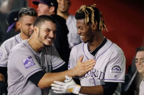 PHOENIX, AZ – JULY 20: Raimel Tapia #15 of the Colorado Rockies (R) is congratulated by teammate Nolan Arenado #28 after Tapia hit a grand slam home run against the Arizona Diamondbacks during the seventh inning of an MLB game at Chase Field on July 20, 2018 in Phoenix, Arizona. (Photo by Ralph Freso/Getty Images)