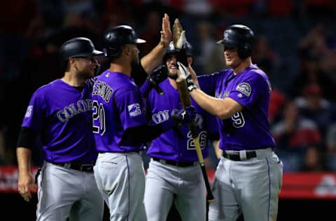 ANAHEIM, CA – AUGUST 27: Ian Desmond #20, David Dahl #26, and Chris Iannetta #22 congratulate DJ LeMahieu #9 of the Colorado Rockies after his grand slam homerun during the eighth inning of a game against the Los Angeles Angels of Anaheim at Angel Stadium on August 27, 2018 in Anaheim, California. (Photo by Sean M. Haffey/Getty Images)