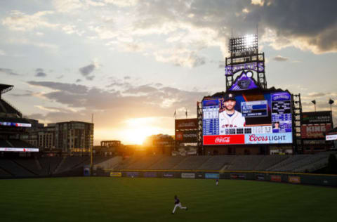 DENVER, CO – AUGUST 19: The sun sets over the stadium as Charlie Blackmon #19 of the Colorado Rockies jogs after a foul ball during the third inning against the Houston Astros at Coors Field on August 19, 2020 in Denver, Colorado. (Photo by Justin Edmonds/Getty Images)