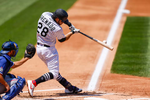 DENVER, CO – AUGUST 16: Nolan Arenado #28 of the Colorado Rockies hits the baseball during the second inning against the Texas Rangers at Coors Field on August 16, 2020 in Denver, Colorado. (Photo by Justin Edmonds/Getty Images)