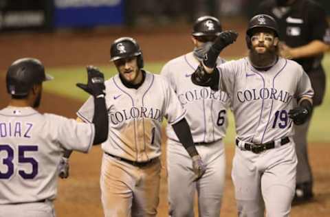 PHOENIX, ARIZONA – AUGUST 26: Charlie Blackmon #19 of the Colorado Rockies is congratulated by Elias Diaz #35, Garrett Hampson #1 and Drew Butera #6 after hitting a grand-slam home run against the Arizona Diamondbacks during the eighth inning of the MLB game at Chase Field on August 26, 2020 in Phoenix, Arizona. (Photo by Christian Petersen/Getty Images)