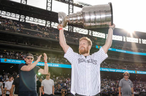 DENVER, COLORADO - JUNE 29: Gabriel Landeskog #92 of the Colorado Avalanche celebrates with the Stanley Cup prior to the game against the Colorado Rockies and Los Angeles Dodgers at Coors Field on June 29, 2022 in Denver, Colorado. (Photo by Harrison Barden/Colorado Rockies/Getty Images)