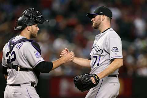 PHOENIX, AZ – SEPTEMBER 22: Pitcher Wade Davis #71 of the Colorado Rockies is congratulated by catcher Chris Iannetta #22 after a 5-1 victory against the Arizona Diamondbacks during an MLB game at Chase Field on September 22, 2018 in Phoenix, Arizona. (Photo by Ralph Freso/Getty Images)