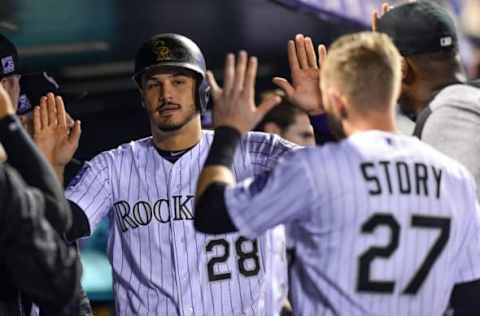 DENVER, CO – SEPTEMBER 24: Nolan Arenado #28 of the Colorado Rockies is congratulated in the dugout by Trevor Story #27 after scoring a run in the third inning of a game against the Philadelphia Phillies at Coors Field on September 24, 2018 in Denver, Colorado. (Photo by Dustin Bradford/Getty Images)