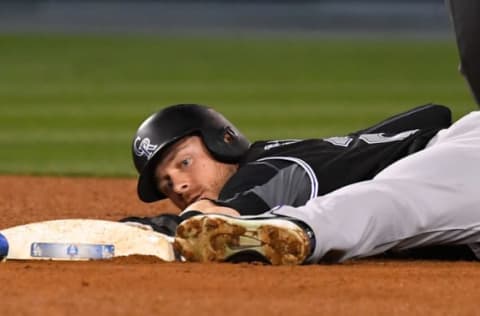 LOS ANGELES, CA – MAY 22: Trevor Story #27 of the Colorado Rockies beats the tag by Logan Forsythe #11 of the Los Angeles Dodgers for a stolen base in the sixth inning of the game at Dodger Stadium on May 22, 2018 in Los Angeles, California. (Photo by Jayne Kamin-Oncea/Getty Images)