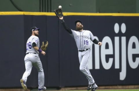 MILWAUKEE, WI – OCTOBER 04: Charlie Blackmon #19 of the Colorado Rockies catches a fly ball next to teammate David Dahl #26 during the seventh inning of Game One of the National League Division Series against the Milwaukee Brewers at Miller Park on October 4, 2018 in Milwaukee, Wisconsin. (Photo by Dylan Buell/Getty Images)