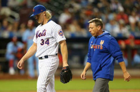 NEW YORK, NEW YORK – JUNE 15: Noah Syndergaard #34 of the New York Mets walks off the field with head trainer Brian Chicklo in the seventh inning during the game against the St. Louis Cardinals at Citi Field on June 15, 2019 in New York City. (Photo by Mike Stobe/Getty Images)