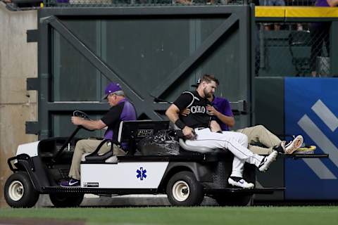 DENVER, COLORADO – AUGUST 02: David Dahl #26 of the Colorado Rockies is carted off the field after being injured in the sixth inning against the San Francisco Giants at Coors Field on August 02, 2019 in Denver, Colorado. (Photo by Matthew Stockman/Getty Images)