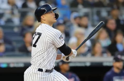 NEW YORK, NEW YORK – OCTOBER 05: Giancarlo Stanton #27 of the New York Yankees hits a sacrifice fly to score Aaron Judge #99 in the third inning of game two of the American League Division Series at Yankee Stadium on October 05, 2019 in New York City. (Photo by Elsa/Getty Images)