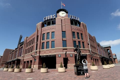 DENVER, COLORADO, – MARCH 26: People stop in front of Coors Field on what was to be opening day for Major League Baseball on March 26, 2020 in Denver, Colorado. Major League Baseball has postponed the start of its season indefinitely due to the coronavirus (COVID-19) outbreak. (Photo by Matthew Stockman/Getty Images)