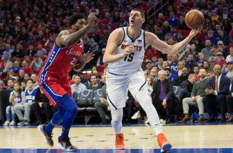 Feb 8, 2019; Philadelphia, PA, USA; Denver Nuggets center Nikola Jokic (15) shoots the ball past Philadelphia 76ers center Joel Embiid (21) during the first quarter at Wells Fargo Center. Mandatory Credit: Bill Streicher-USA TODAY Sports