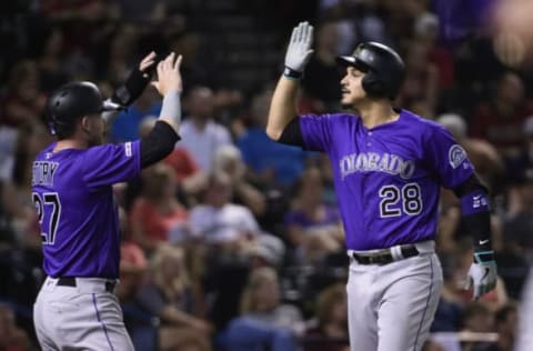 Aug 20, 2019; Phoenix, AZ, USA; Colorado Rockies third baseman Nolan Arenado (28) celebrates with shortstop Trevor Story (27) after hitting a two-run home run in the fourth inning against the Arizona Diamondbacks at Chase Field. Mandatory Credit: Jennifer Stewart-USA TODAY Sports