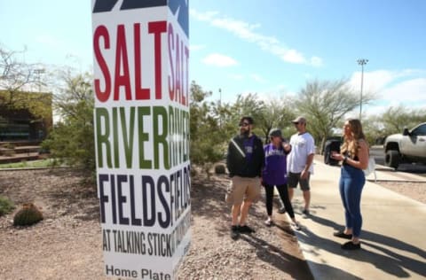 March 13, 2020; Scottsdale, AZ, USA; Jacob Saunders (white jersey) from Denver and his family stand outside Salt River Fields at Talking Stick. Saunders and family members drove from Colorado to attend a Colorado Rockies game today but Major League Baseball suspended the 2020 spring training season last night in response to the COVID-19 virus health emergency. Mandatory Credit: Rob Schumacher/The Republic via USA Today Network