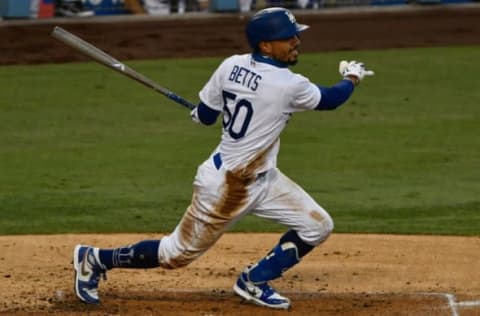 Sep 5, 2020; Los Angeles, California, USA; Los Angeles Dodgers right fielder Mookie Betts (50) singles in the third inning against the Colorado Rockies at Dodger Stadium. Mandatory Credit: Robert Hanashiro-USA TODAY Sports