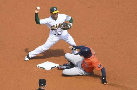 Oct 5, 2020; Los Angeles, California, USA; Oakland Athletics second baseman Tommy La Stella (3) forces out Houston Astros center fielder George Springer (4) during the first inning in game one of the 2020 ALDS at Dodger Stadium. Mandatory Credit: Jayne Kamin-Oncea-USA TODAY Sports