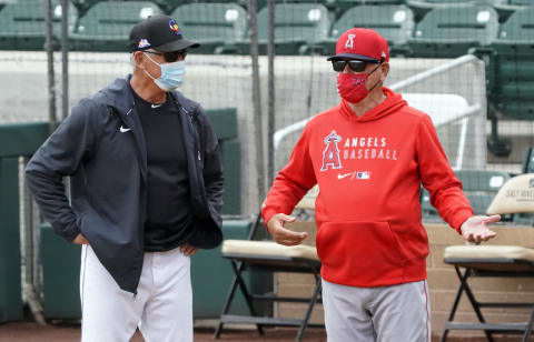 Mar 25, 2021; Salt River Pima-Maricopa, Arizona, USA; Colorado Rockies manger Bud Black and Los Angeles Angels manager Joe Maddon talk before a spring training game at Salt River Fields at Talking Stick. They were coaches on the Angels together from 2000 through 2006. Mandatory Credit: Rick Scuteri-USA TODAY Sports