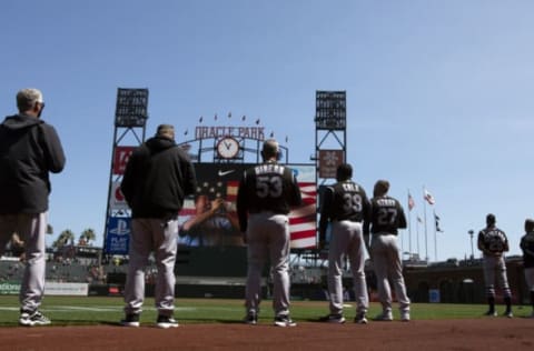 Apr 10, 2021; San Francisco, California, USA; Colorado Rockies players and coaches look on during the playing of the national anthem before the game against the San Francisco Giants at Oracle Park. Mandatory Credit: D. Ross Cameron-USA TODAY Sports