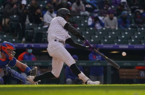 Apr 17, 2021; Denver, Colorado, USA; Colorado Rockies left fielder Raimel Tapia (15) hits a solo home run in the fifth inning against the New York Mets at Coors Field. Mandatory Credit: Ron Chenoy-USA TODAY Sports