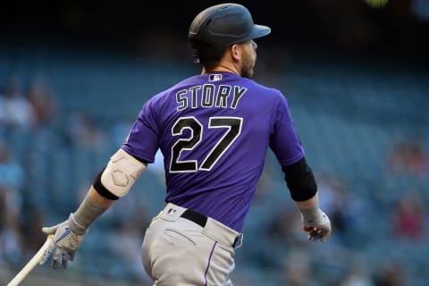 Apr 30, 2021; Phoenix, Arizona, USA; Colorado Rockies shortstop Trevor Story (27) hits a single against the Arizona Diamondbacks during the first inning at Chase Field. Mandatory Credit: Joe Camporeale-USA TODAY Sports