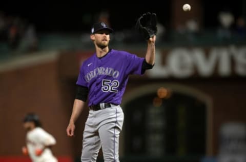 Apr 27, 2021; San Francisco, California, USA; Colorado Rockies pitcher Daniel Bard gets a new baseball while San Francisco Giants shortstop Brandon Crawford runs out his solo home run during the ninth inning at Oracle Park. Mandatory Credit: D. Ross Cameron-USA TODAY Sports