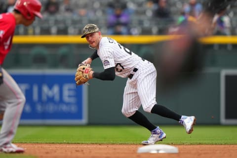 May 16, 2021; Denver, Colorado, USA; Colorado Rockies shortstop Trevor Story (27) fields the ball in the fifth inning against the Cincinnati Reds at Coors Field. Mandatory Credit: Ron Chenoy-USA TODAY Sports