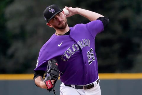 Jun 19, 2021; Denver, Colorado, USA; Colorado Rockies starting pitcher Austin Gomber (26) delivers a pitch against the Milwaukee Brewers in the first inning at Coors Field. Mandatory Credit: Ron Chenoy-USA TODAY Sports