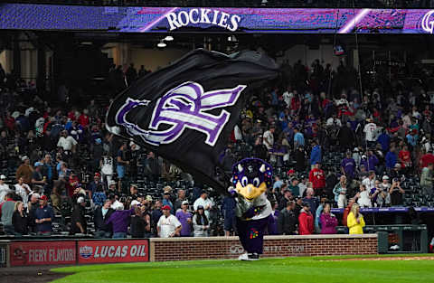 Jul 1, 2021; Denver, Colorado, USA; Colorado Rockies mascot Dinger celebrates a win against the St. Louis Cardinals at Coors Field. Mandatory Credit: Troy Babbitt-USA TODAY Sports