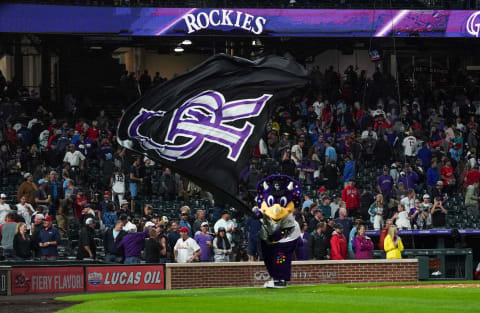 Jul 1, 2021; Denver, Colorado, USA; Colorado Rockies mascot Dinger celebrates a win against the St. Louis Cardinals at Coors Field. Mandatory Credit: Troy Babbitt-USA TODAY Sports