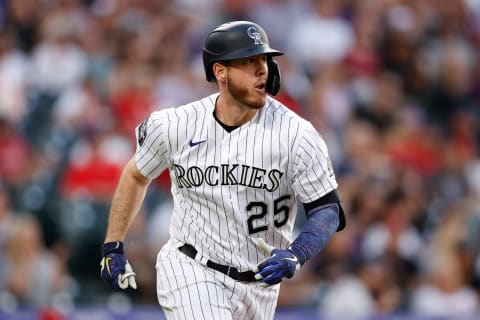 Jul 2, 2021; Denver, Colorado, USA; Colorado Rockies first baseman C.J. Cron (25) hits an RBI double in the sixth inning against the St. Louis Cardinals at Coors Field. Mandatory Credit: Isaiah J. Downing-USA TODAY Sports