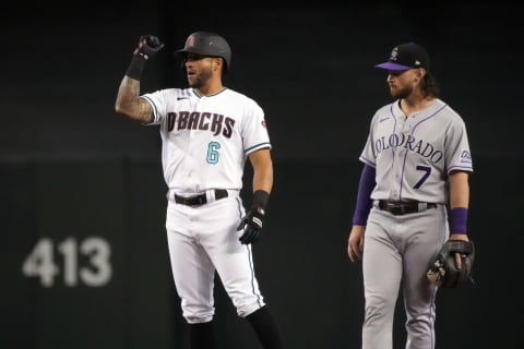 Arizona Diamondbacks left fielder David Peralta (6) reacts after hitting an RBI double next to Colorado Rockies shortstop Brendan Rodgers (7) in the first inning at Chase Field. Mandatory Credit: Rick Scuteri-USA TODAY Sports