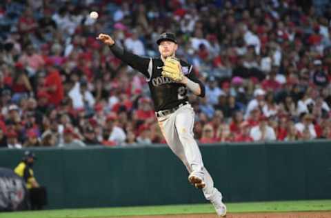 Jul 26, 2021; Anaheim, California, USA; Colorado Rockies shortstop Trevor Story (27) throws to first for the out against Los Angeles Angels right fielder Adam Eaton (9) during the fourth inning at Angel Stadium. Mandatory Credit: Richard Mackson-USA TODAY Sports