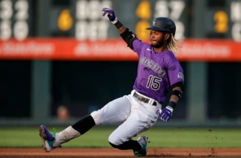 Aug 4, 2021; Denver, Colorado, USA; Colorado Rockies left fielder Raimel Tapia (15) slides into second base with a double against the Chicago Cubs in the first inning at Coors Field. Mandatory Credit: Isaiah J. Downing-USA TODAY Sports