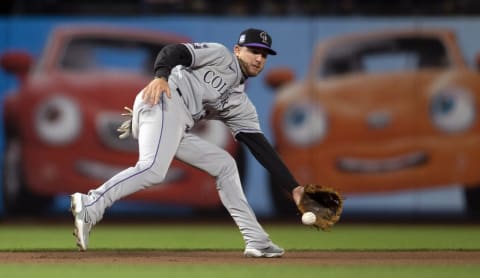 Aug 14, 2021; San Francisco, California, USA; Colorado Rockies third baseman Ryan McMahon (24) fields a grounder off the bat of San Francisco Giants first baseman Darin Ruf during the ninth inning at Oracle Park. Mandatory Credit: D. Ross Cameron-USA TODAY Sports