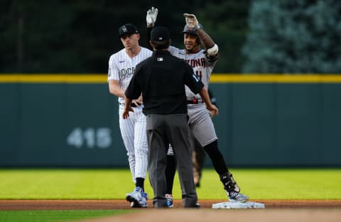 Aug 20, 2021; Denver, Colorado, USA; Arizona Diamondbacks second baseman Ketel Marte (4) reacts to his double next to Colorado Rockies shortstop Trevor Story (27) in the first inning at Coors Field. Mandatory Credit: Ron Chenoy-USA TODAY Sports