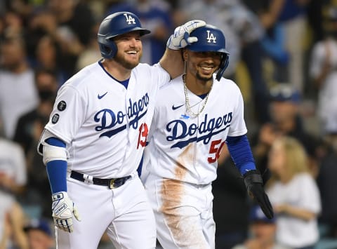 Sep 14, 2021; Los Angeles, California, USA; Los Angeles Dodgers first baseman Max Muncy (13) returns to the dugout after hitting a two run home run to score right fielder Mookie Betts (50) against the Arizona Diamondbacks in the third inning at Dodger Stadium. Mandatory Credit: Jayne Kamin-Oncea-USA TODAY Sports