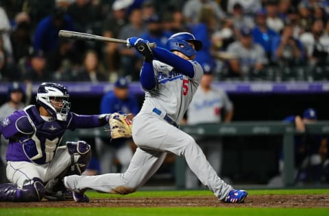 Los Angeles Dodgers shortstop Corey Seager (5) singles against the Colorado Rockies in the fifth inning at Coors Field. Mandatory Credit: Ron Chenoy-USA TODAY Sports