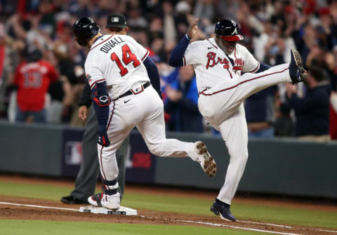 Oct 31, 2021; Atlanta, Georgia, USA; Atlanta Braves center fielder Adam Duvall (14) celebrates his first inning grand slam home run with first base coach Eric Young Sr. (2) against the Houston Astros in game five of the 2021 World Series at Truist Park. Mandatory Credit: Brett Davis-USA TODAY Sports