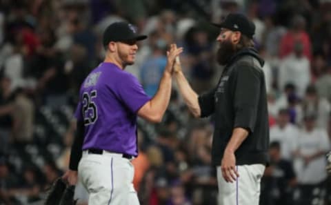 Aug 23, 2022; Denver, Colorado, USA; Colorado Rockies first baseman C.J. Cron (25) and designated hitter Charlie Blackmon (19) celebrate defeating the Texas Rangers at Coors Field. Mandatory Credit: Ron Chenoy-USA TODAY Sports