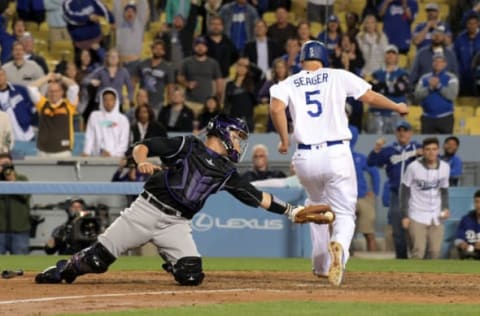 Apr 18, 2017; Los Angeles, CA, USA; Los Angeles Dodgers shortstop Corey Seager (5) beats a throw to Colorado Rockies catcher Dustin Garneau (13) to score in the ninth inning during a MLB baseball game at Dodger Stadium. The Rockies defeated the Dodgers 4-3. Mandatory Credit: Kirby Lee-USA TODAY Sports