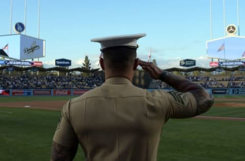 Apr 18, 2017; Los Angeles, CA, USA; A military member stands at attention during the playing of the national anthem before a MLB baseball game between the Colorado Rockies and the Los Angeles Dodgers at Dodger Stadium. Mandatory Credit: Kirby Lee-USA TODAY Sports